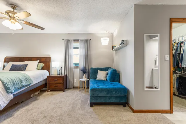a bedroom with bed and a chandelier