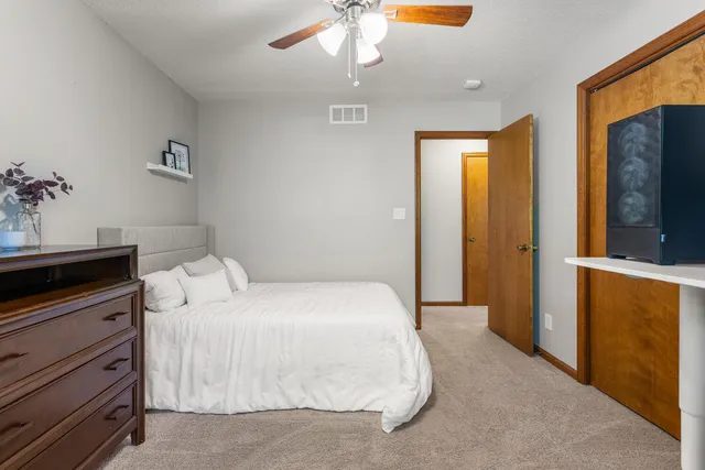 a bedroom with a bed and a dresser