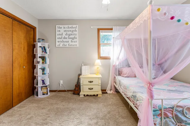 a bedroom with a bed and a window