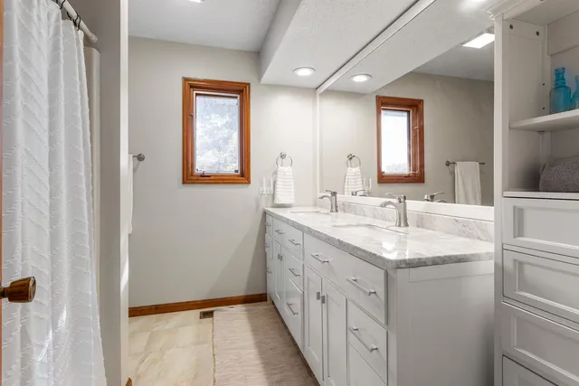a bathroom with a double vanity sink and mirror
