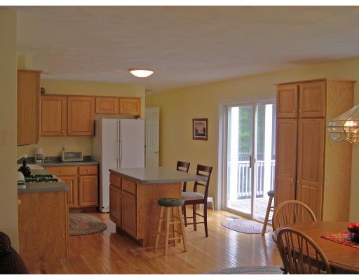6 Wells Fargo Road Chelmsford, MA 01824 - Photo 2 of 28 a kitchen with a table chairs refrigerator and cabinets