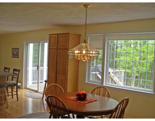 6 Wells Fargo Road Chelmsford, MA 01824 - Photo 3 of 28 a dining room with furniture a chandelier and wooden floor
