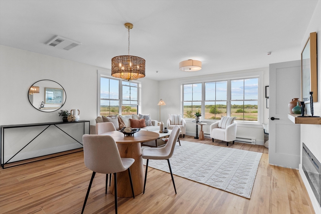 30 Cable Avenue, Unit 3 Salisbury, MA 01952 - Photo 16 of 31 a living room with furniture a rug a lamp and a large window