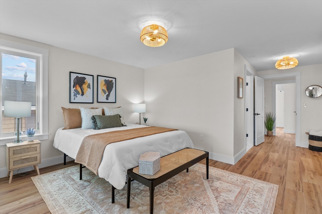 30 Cable Avenue, Unit 3 Salisbury, MA 01952 - Photo 19 of 31 a bedroom with a bed and painting on the wall