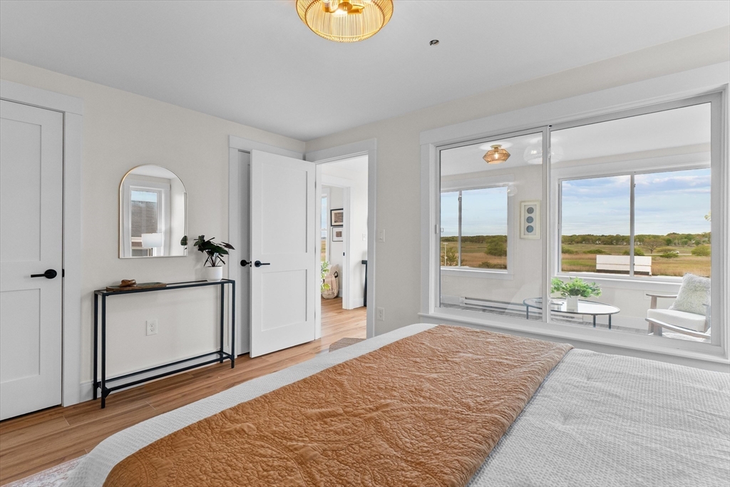 30 Cable Avenue, Unit 3 Salisbury, MA 01952 - Photo 20 of 31 a bedroom with a bed and a view of living room