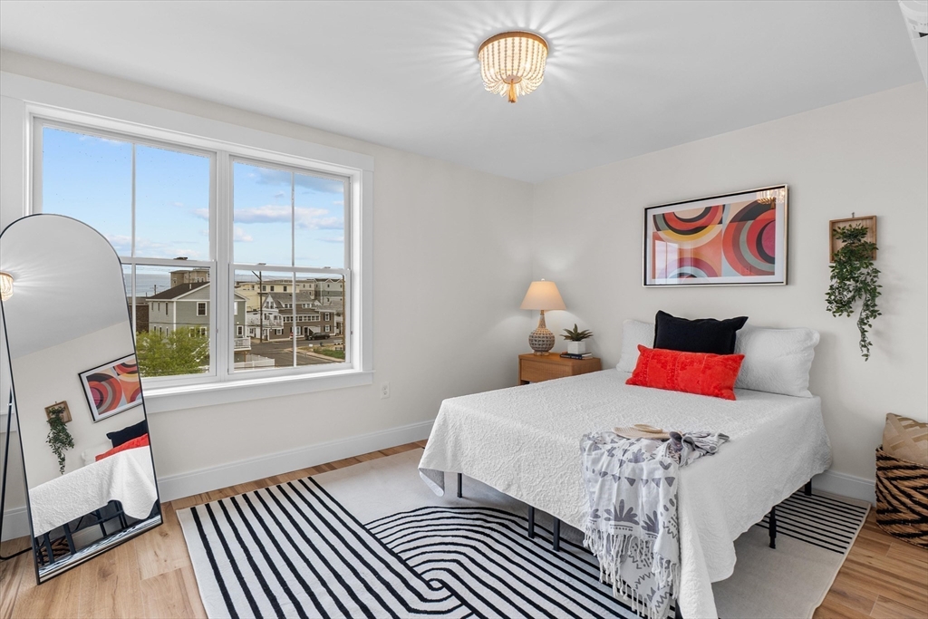 30 Cable Avenue, Unit 3 Salisbury, MA 01952 - Photo 21 of 31 a bedroom with a bed and wooden floor