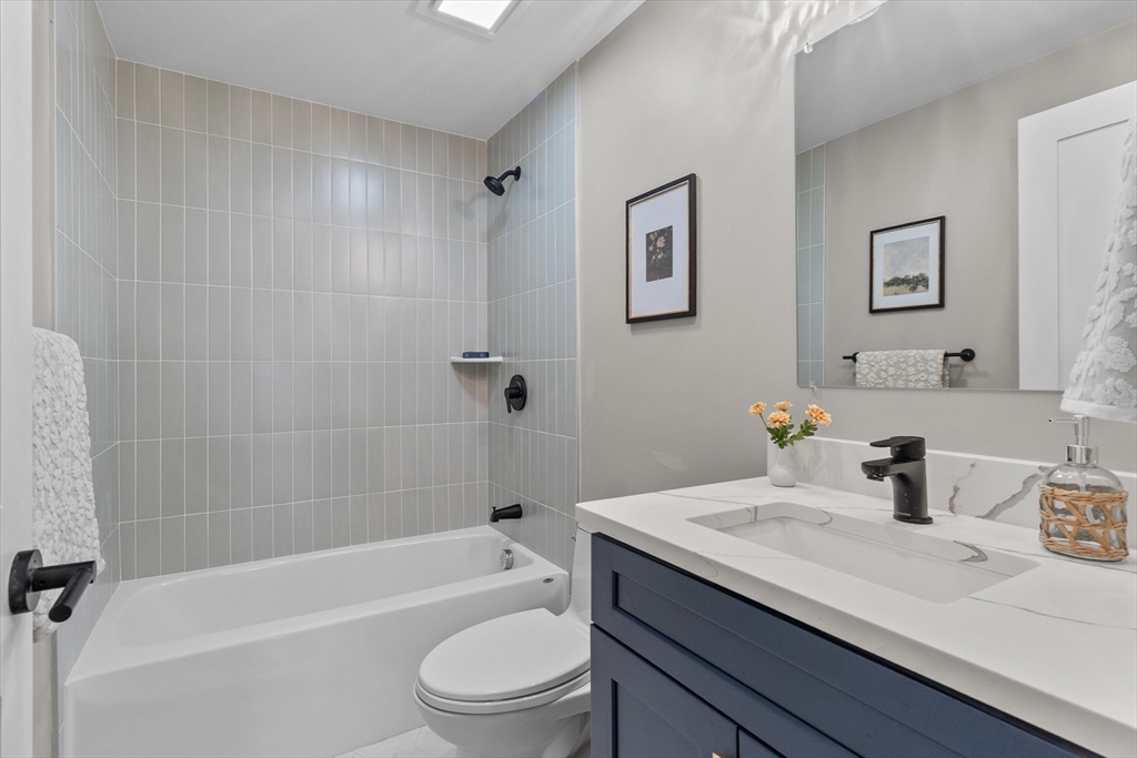30 Cable Avenue, Unit 3 Salisbury, MA 01952 - Photo 24 of 31 a bathroom with a granite countertop sink a toilet and shower