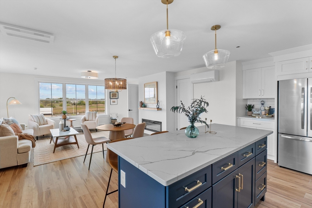 30 Cable Avenue, Unit 3 Salisbury, MA 01952 - Photo 6 of 31 a view of a dining room with furniture a chandelier and wooden floor