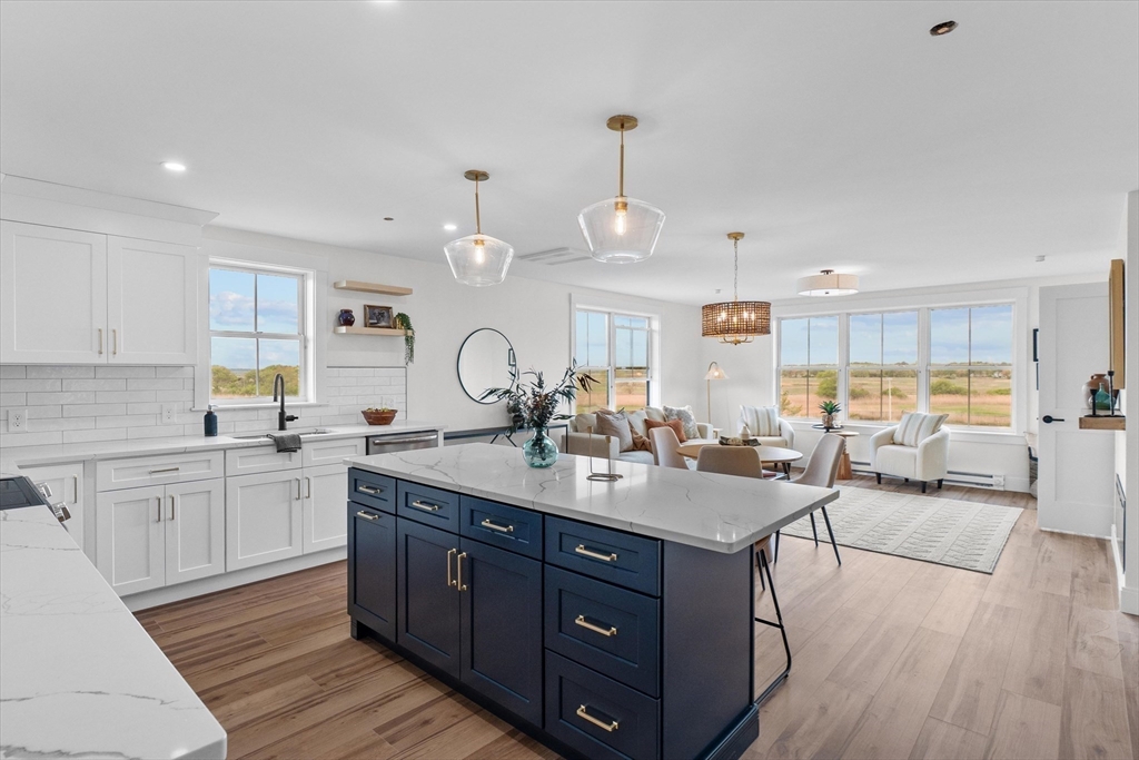 30 Cable Avenue, Unit 3 Salisbury, MA 01952 - Photo 7 of 31 a kitchen with a sink stove and wooden cabinets