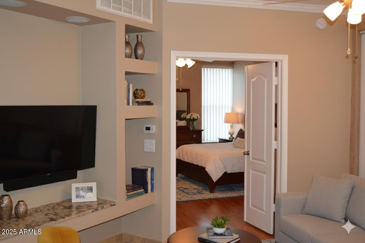 1701 East Colter Street, Unit 112 Phoenix, AZ 85016 - Photo 1 of 47 a bedroom with furniture and a flat screen tv