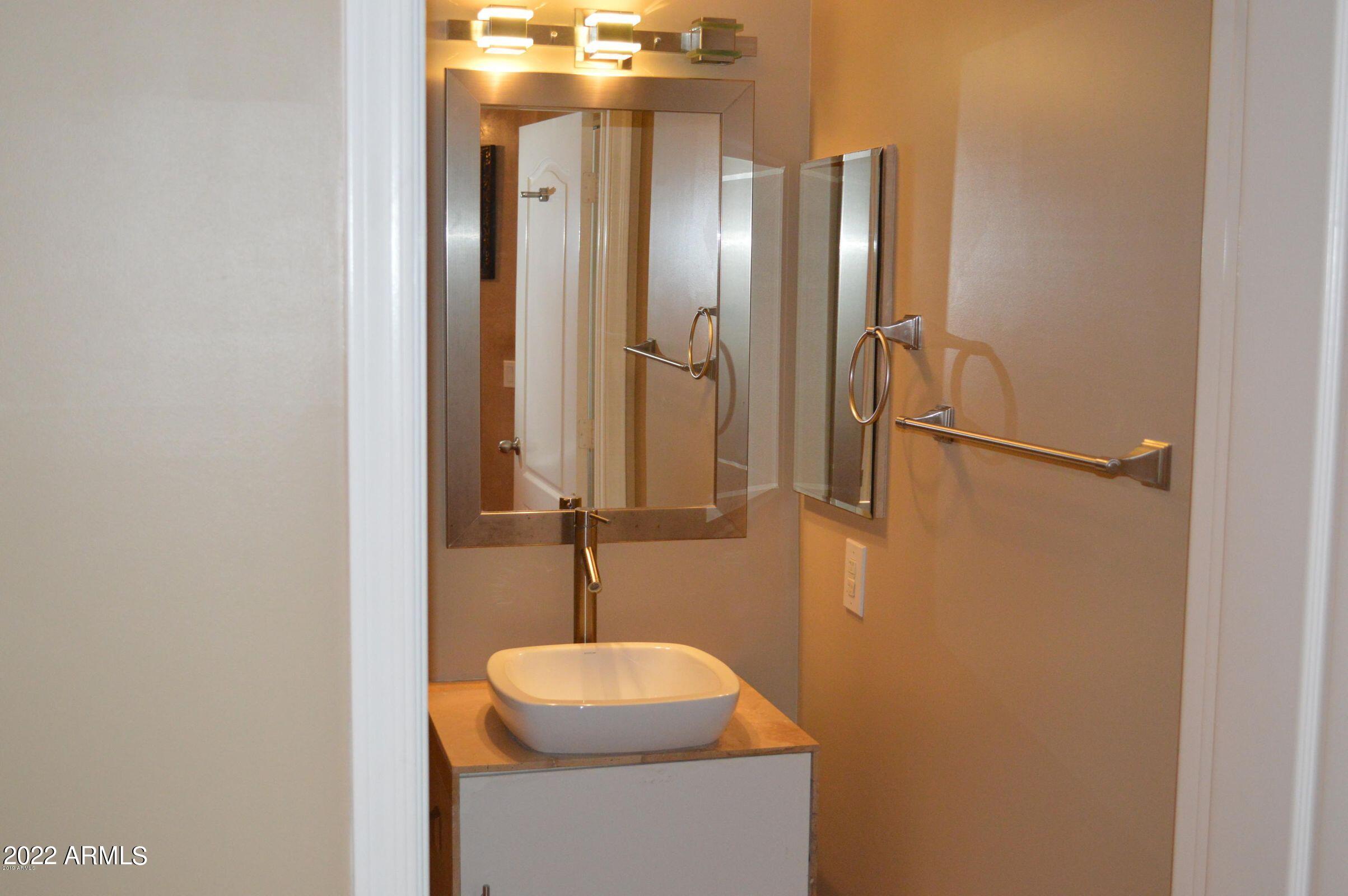 1701 East Colter Street, Unit 112 Phoenix, AZ 85016 - Photo 15 of 47 a bathroom with a sink and a mirror