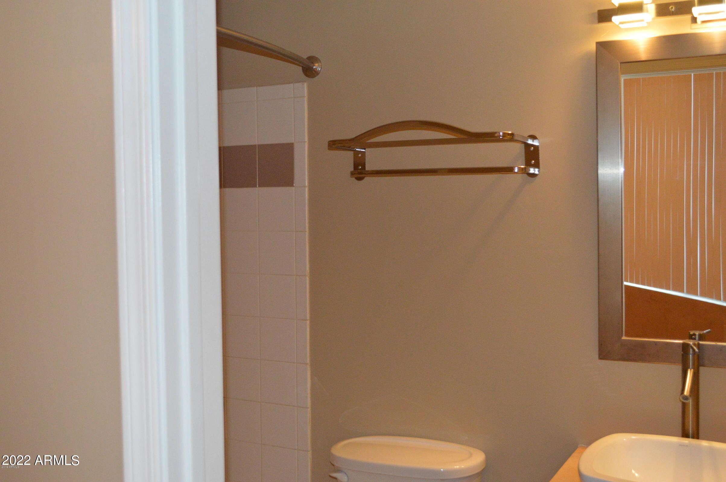 1701 East Colter Street, Unit 112 Phoenix, AZ 85016 - Photo 17 of 47 a bathroom with a toilet and a shower