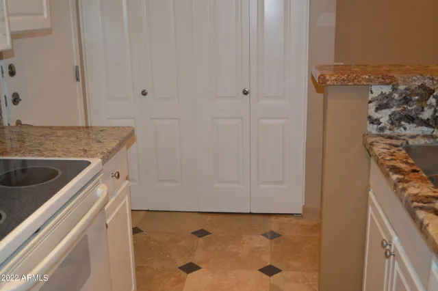 a kitchen with granite countertop a refrigerator and a stove