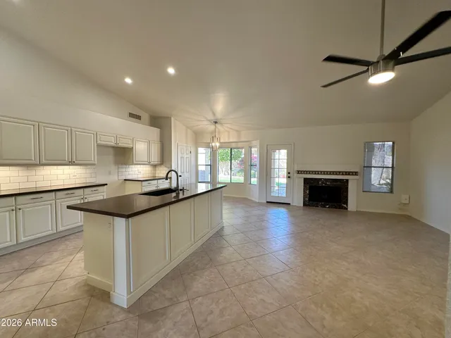 a kitchen with granite countertop a sink and cabinets