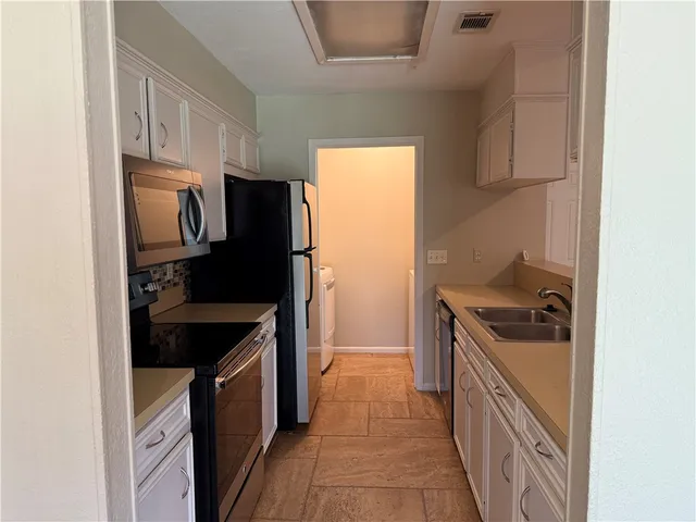 a kitchen with a stove and a refrigerator