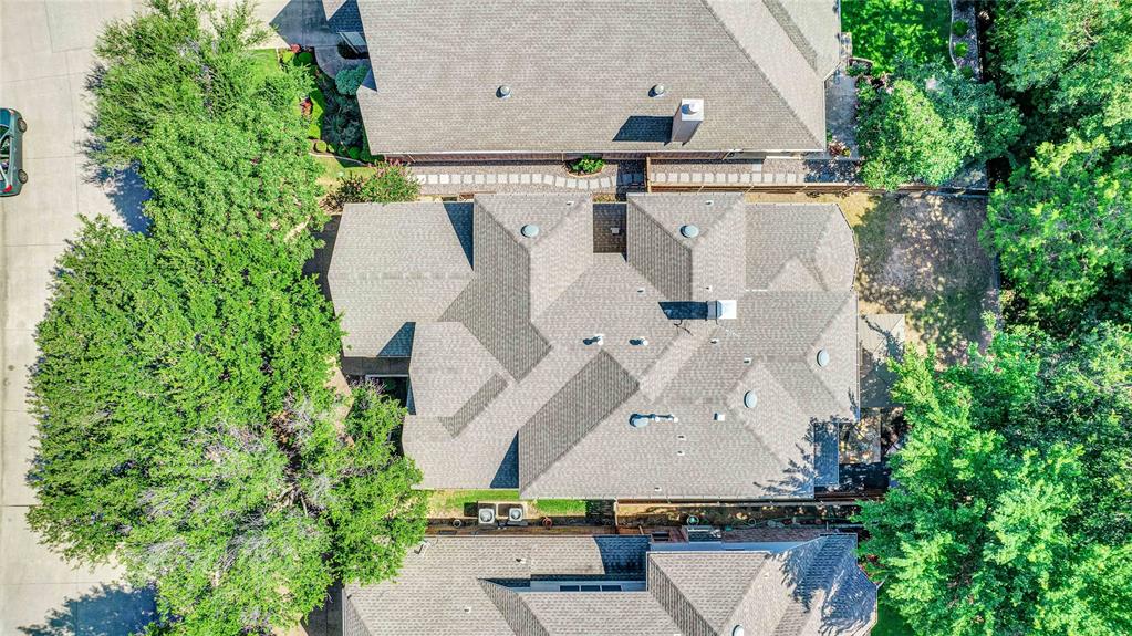 an aerial view of a house with a yard and garden