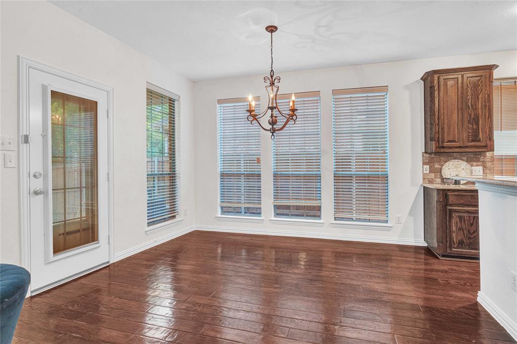 1504 Tangle Ridge Drive McKinney, TX 75071 - Photo 11 of 36 a view of wooden floor and windows in the room