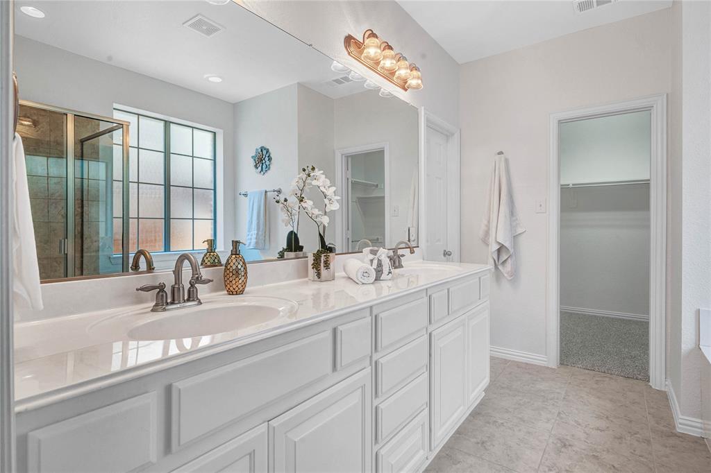 1504 Tangle Ridge Drive McKinney, TX 75071 - Photo 19 of 36 a bathroom with double vanity and a mirror