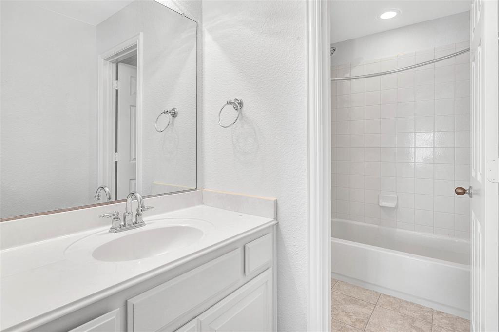 1504 Tangle Ridge Drive McKinney, TX 75071 - Photo 30 of 36 a bathroom with a sink and a mirror