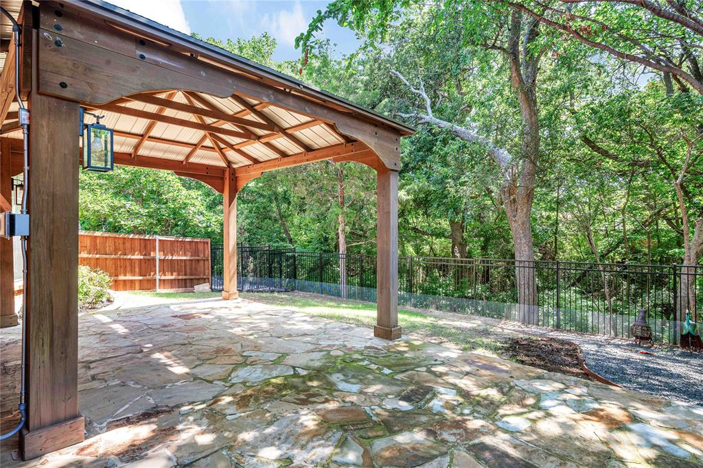 1504 Tangle Ridge Drive McKinney, TX 75071 - Photo 34 of 36 a backyard of a house with large trees and plants