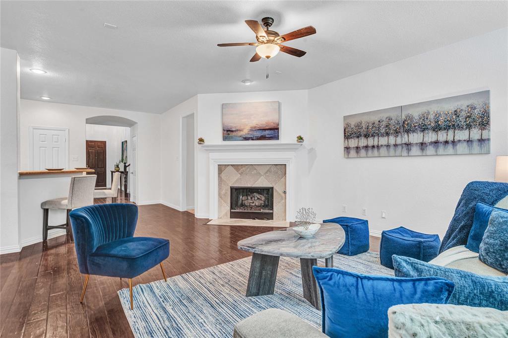 1504 Tangle Ridge Drive McKinney, TX 75071 - Photo 8 of 36 a living room with furniture and a fireplace