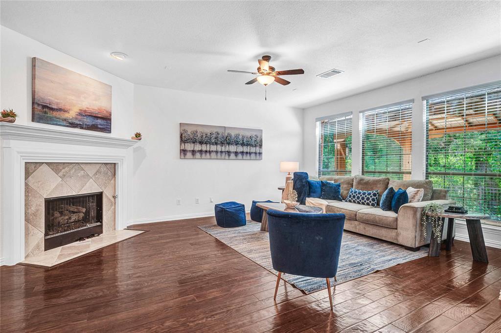 1504 Tangle Ridge Drive McKinney, TX 75071 - Photo 10 of 36 a living room with furniture a large window and a fireplace