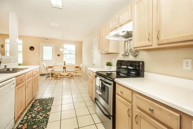 a kitchen with stainless steel appliances a stove a sink and cabinets