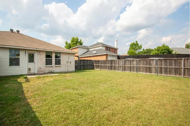 a view of a house with a swimming pool and a yard