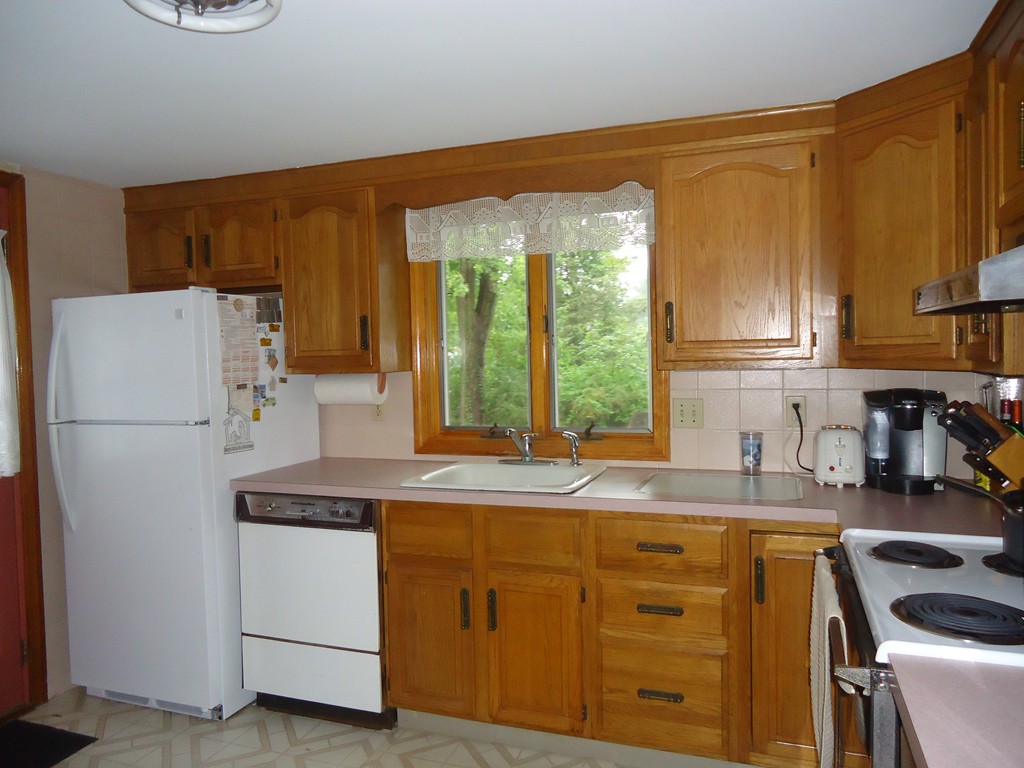 9 Robinson Road Woburn, MA 01801 - Photo 3 of 6 a kitchen with a white cabinets and white appliances