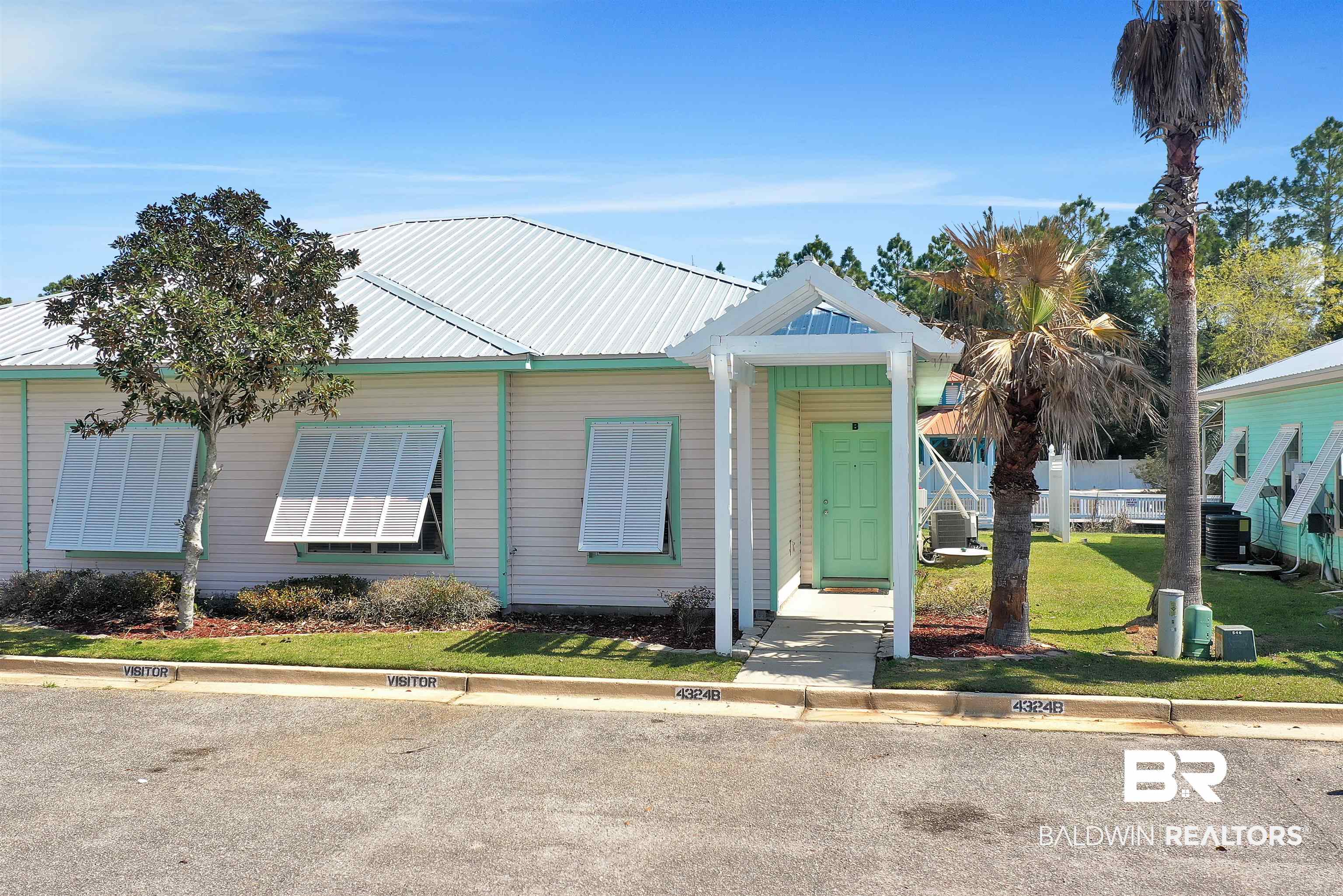 4324 B Lindsey Lane, Unit 4324B Orange Beach, AL 36561 - Photo 22 of 33 View of front facade featuring metal roof, a front lawn, and central AC