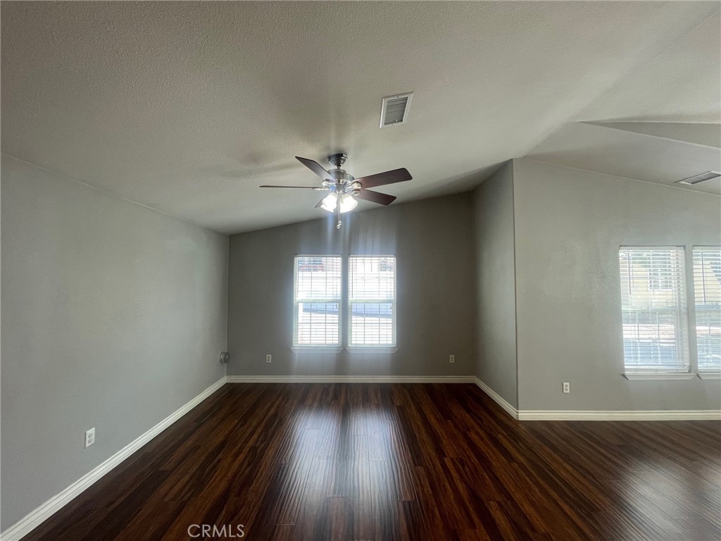 15181 Van Buren Boulevard, Unit 22 Riverside, CA 92504 - Photo 12 of 61 wooden floor in an empty room with a window