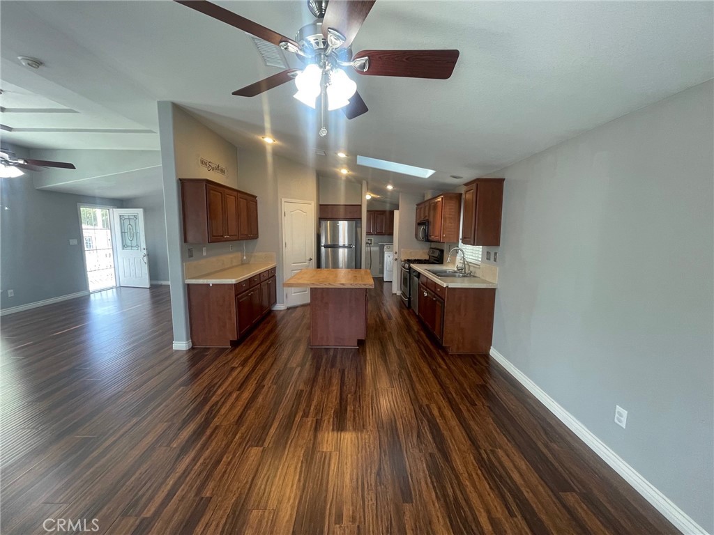 15181 Van Buren Boulevard, Unit 22 Riverside, CA 92504 - Photo 14 of 61 a view of a living room with wooden floor and a ceiling fan