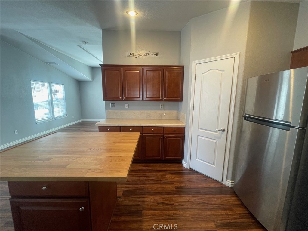15181 Van Buren Boulevard, Unit 22 Riverside, CA 92504 - Photo 19 of 61 a kitchen with granite countertop a refrigerator and a sink