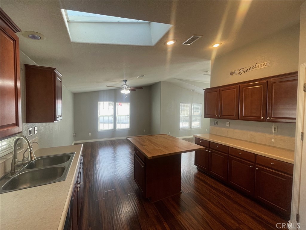 15181 Van Buren Boulevard, Unit 22 Riverside, CA 92504 - Photo 21 of 61 a kitchen with lots of counter space and wooden floor