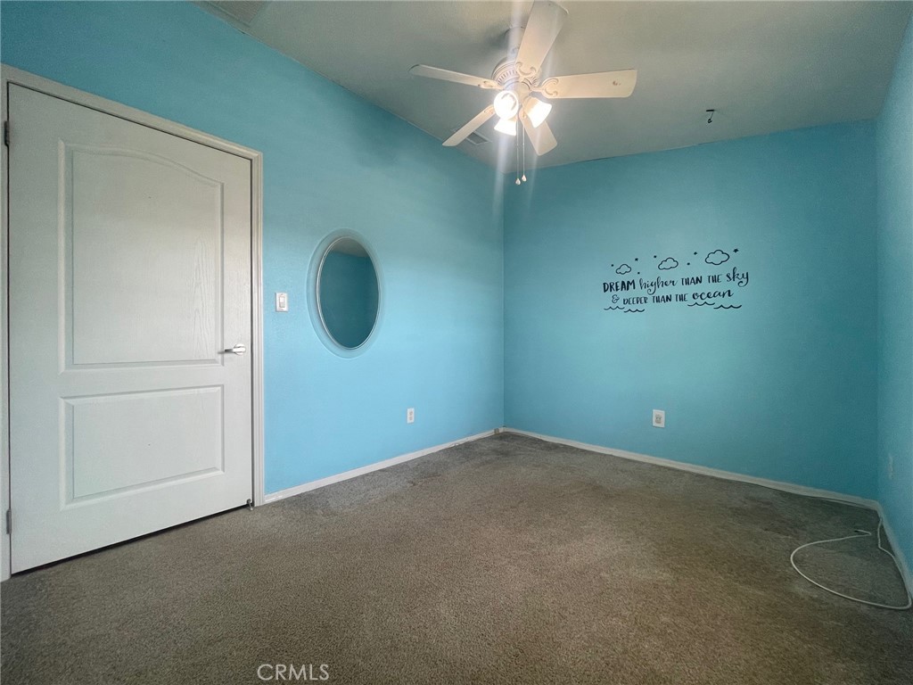 15181 Van Buren Boulevard, Unit 22 Riverside, CA 92504 - Photo 30 of 61 an empty room with a chandelier fan and closet