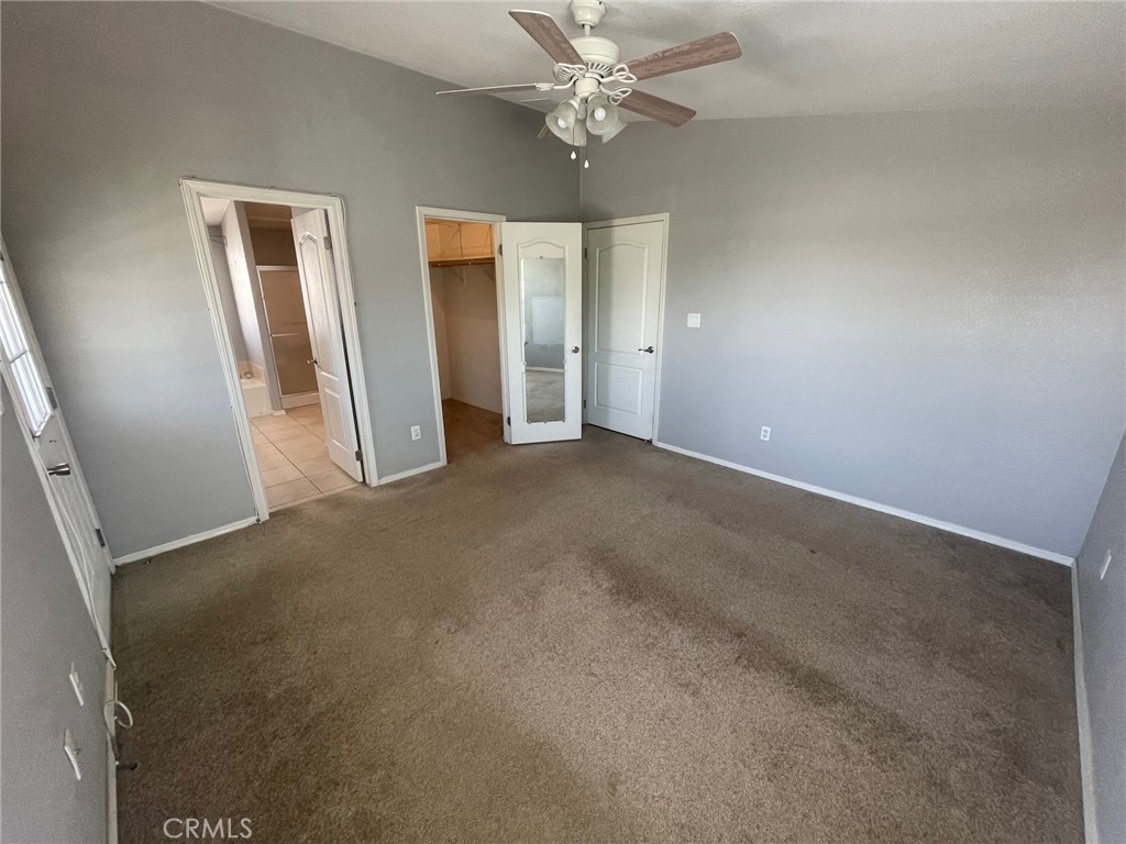 15181 Van Buren Boulevard, Unit 22 Riverside, CA 92504 - Photo 35 of 61 an empty room with closet and a chandelier fan