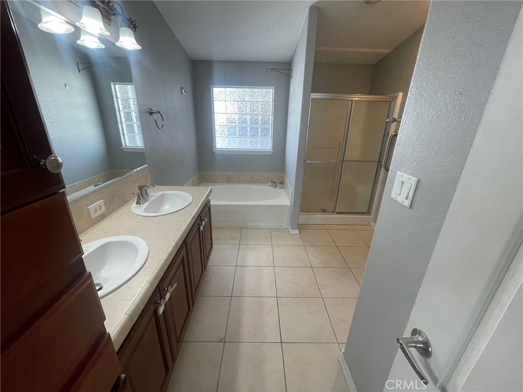 15181 Van Buren Boulevard, Unit 22 Riverside, CA 92504 - Photo 38 of 61 a bathroom with a sink a toilet and mirror