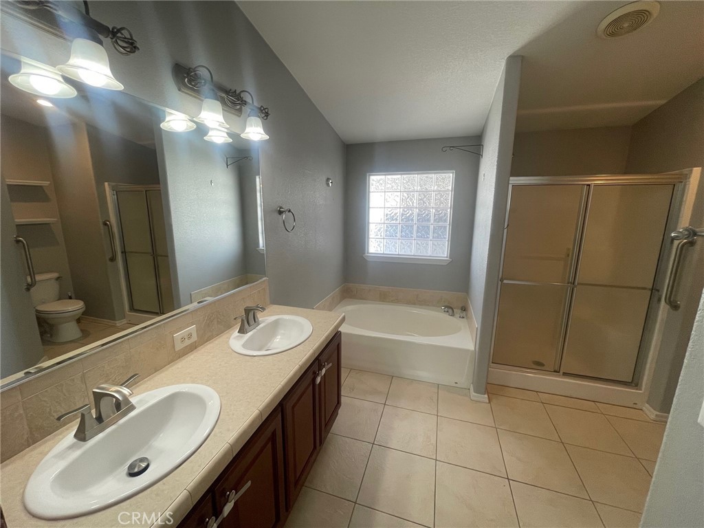 15181 Van Buren Boulevard, Unit 22 Riverside, CA 92504 - Photo 39 of 61 a bathroom with a sink and a mirror