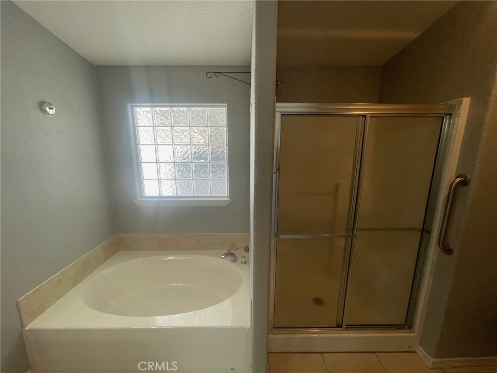15181 Van Buren Boulevard, Unit 22 Riverside, CA 92504 - Photo 40 of 61 a bathroom with a bathtub