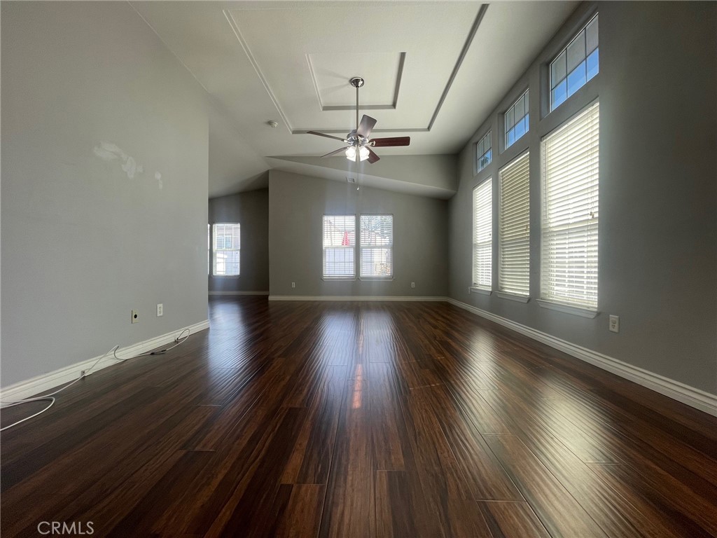 15181 Van Buren Boulevard, Unit 22 Riverside, CA 92504 - Photo 6 of 61 an empty room with wooden floor and windows