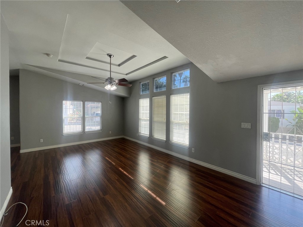15181 Van Buren Boulevard, Unit 22 Riverside, CA 92504 - Photo 7 of 61 an empty room with wooden floor and windows