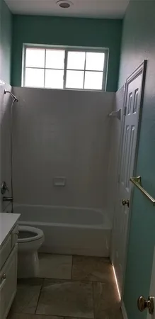 a bathroom with a toilet a sink and a window