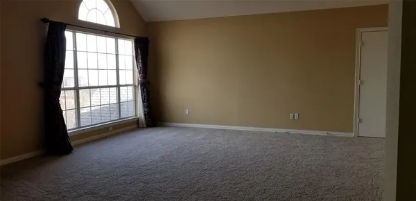 an empty room with windows and yard
