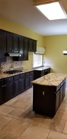 a kitchen with a stove and a sink