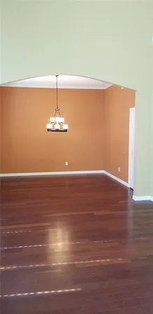 a view of a room with wooden floor