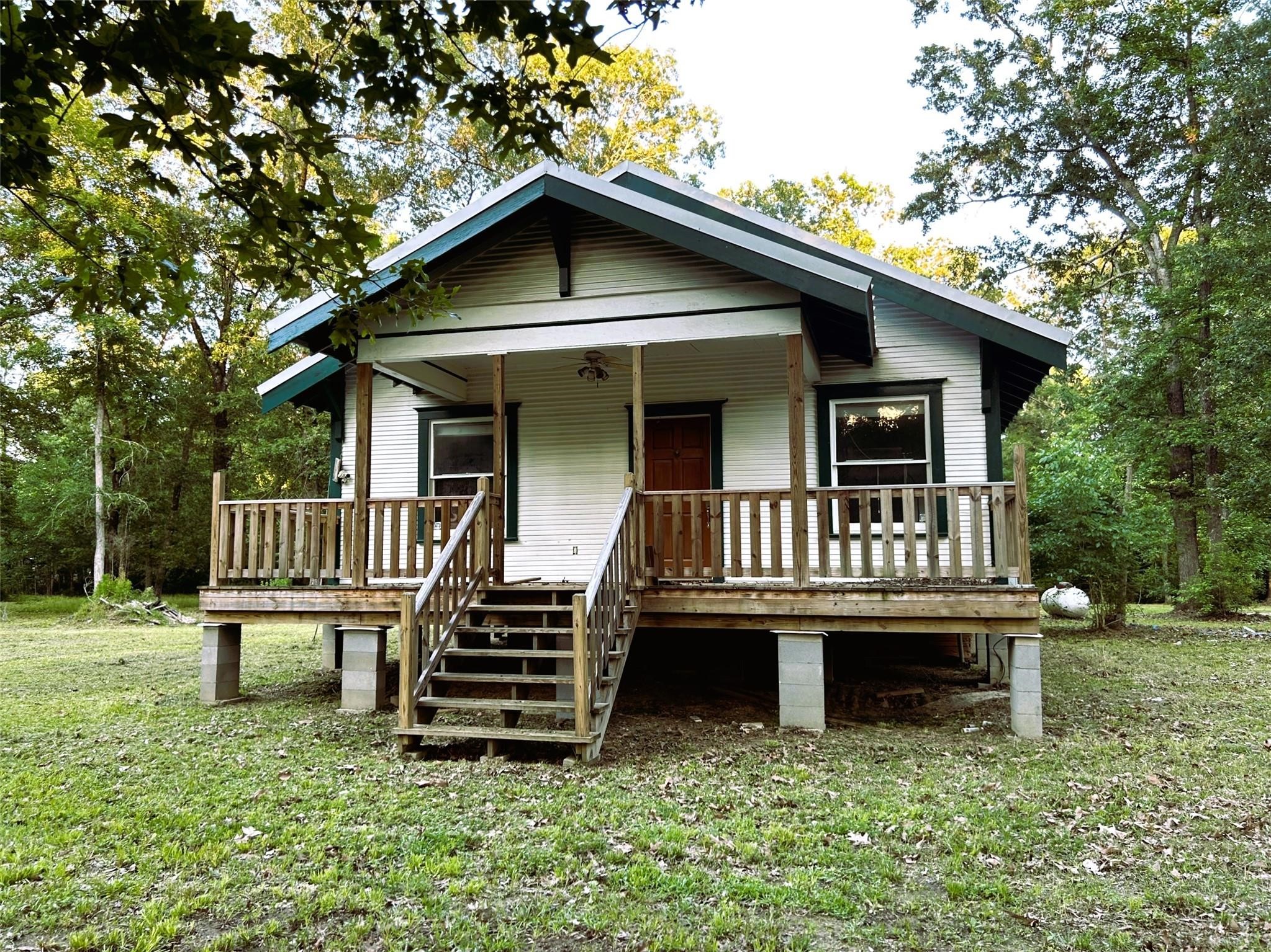 877 County Road 6474 Dayton, TX 77535 - Photo 1 of 27 a view of a house with a deck and a yard