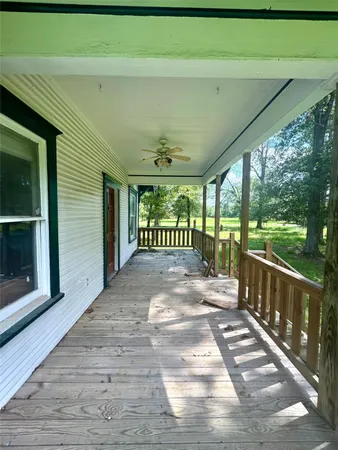 a view of a porch with furniture and garden