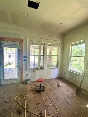 a spacious bathroom with a granite countertop tub sink and window