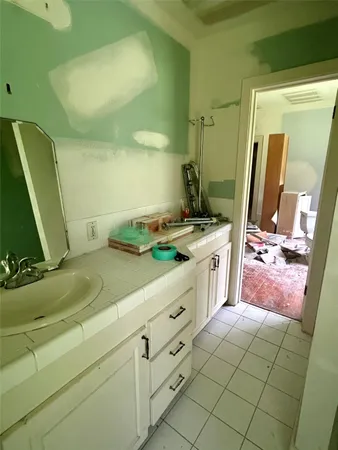 a bathroom with a sink a vanity and a mirror