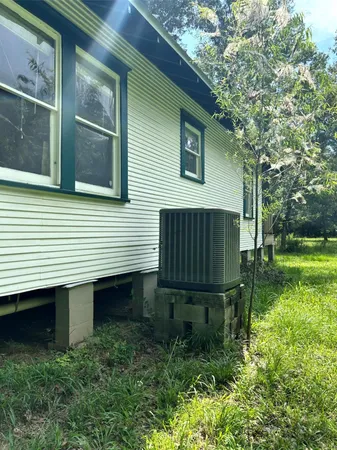 a wooden bench sitting in front of a house
